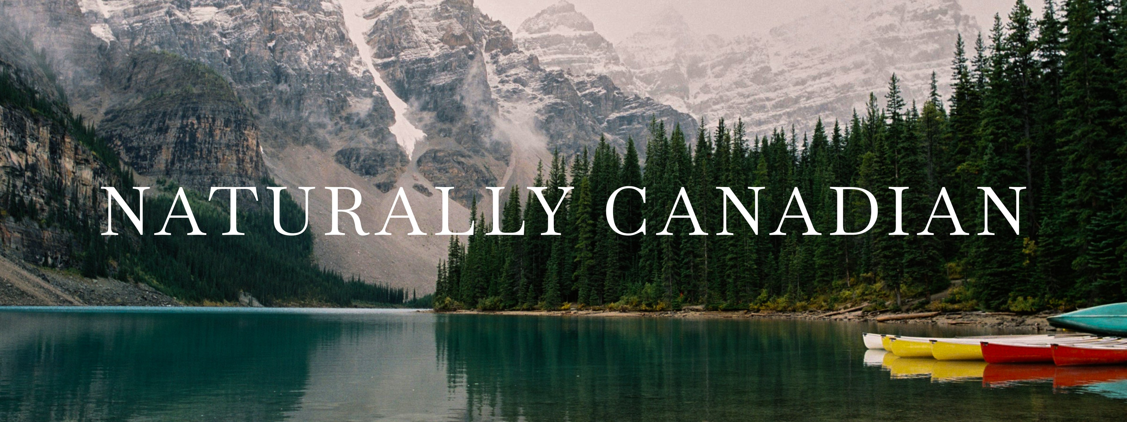 Text that says Naturally Canadian is superimposed over an idyllic lake scene in the Canadian Rockies.