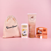 A Green Beaver bundle of Vanilla Bliss Antiperspirant, Coconut Body Lotion, Maple Lip Balm, all with a jute bag and on a pink background.