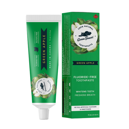 A tube of green apple natural toothpaste from Green Beaver is placed vertically next to its box on a white background.