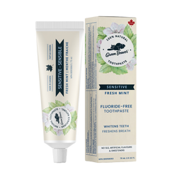A tube of mint sensitive teeth natural toothpaste from Green Beaver is placed vertically next to its box on a white background.