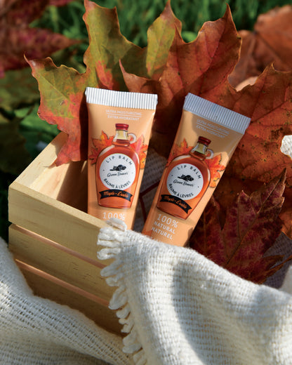 Two natural lip balms in a basket with fall leaves