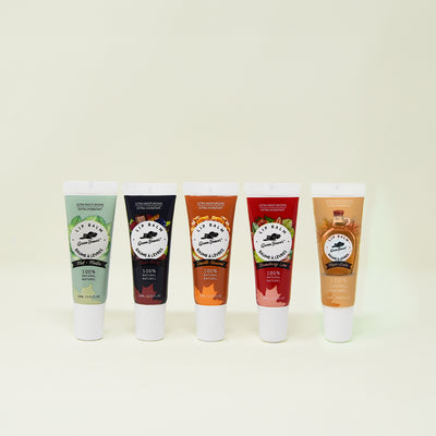 Five natural lip balms displayed on a cream background 