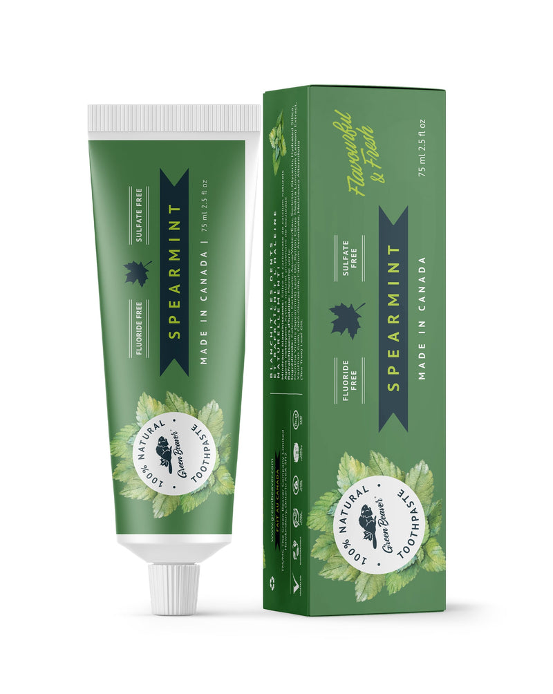 A tube of spearmint natural toothpaste from Green Beaver is placed vertically next to its box on a white background.