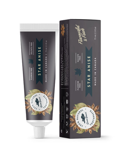 A tube of star anise natural toothpaste from Green Beaver is placed vertically next to its box on a white background.