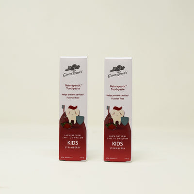 Two boxes of Strawberry-flavoured Naturapeutic Toothpaste for Kids from Green Beaver, sits on a plain background