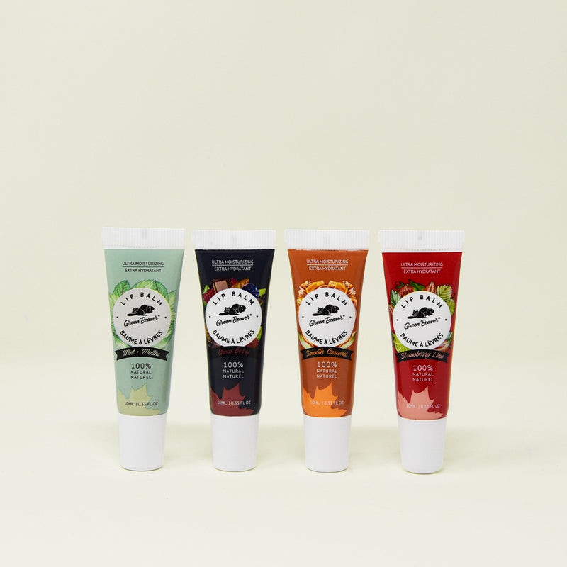 Four tubes of natural lip balm on a plain background.