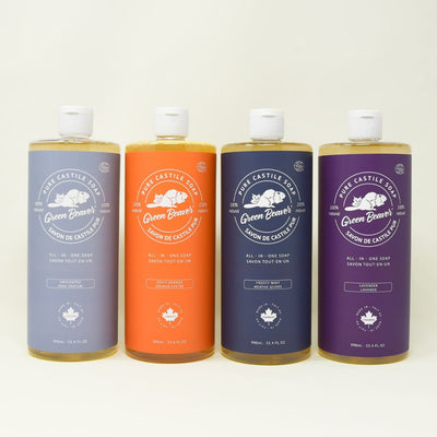 Four bottles of Green Beaver's pure Castile soaps sit on a plain background.
