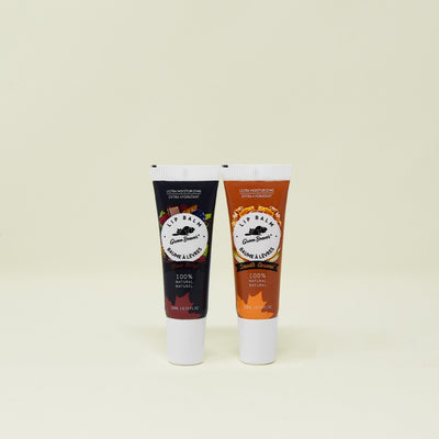 Two tubes of Green Beaver's Choco Berry and Smooth Caramel natural lip balm sit on a beige background.