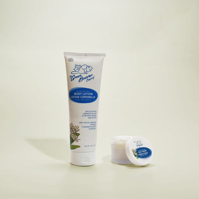 A tube of Extra Dry Skin Body Lotion and a jar of Extra Dry Skin Face Cream from Green Beaver sit on a neutral background